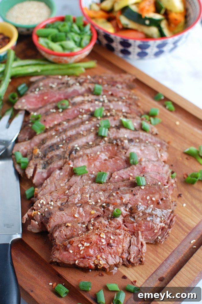 Asian Marinated Flank Steak being sliced with a knife