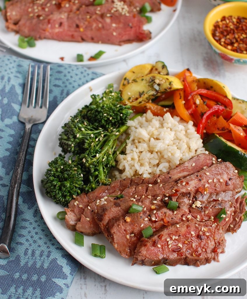 Asian Marinated Flank Steak with a variety of cooked vegetables and rice