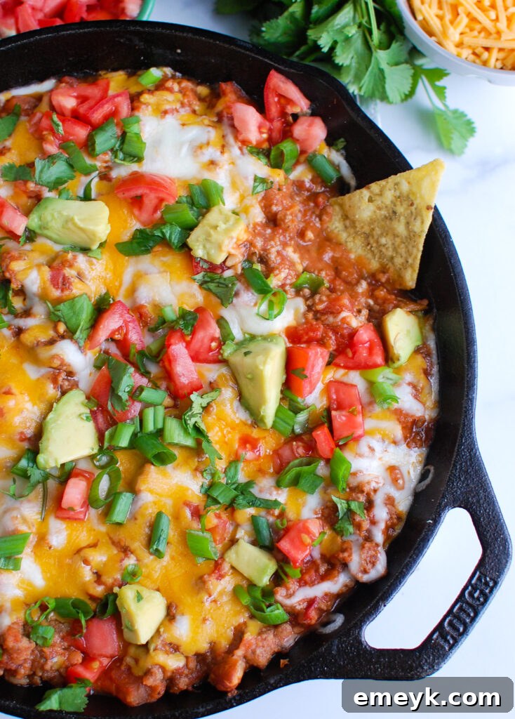 Easy Beef Taco Dip served with a variety of tortilla chips, ready for a party.