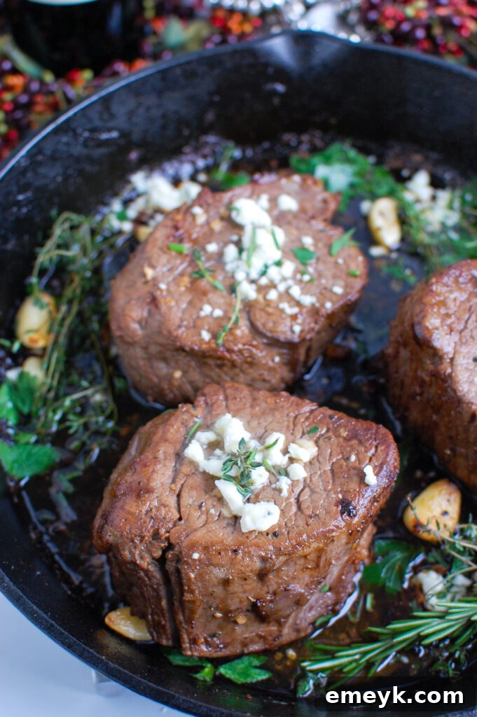 Beef Tenderloin Steaks searing in a hot skillet, ready to be finished in the oven.