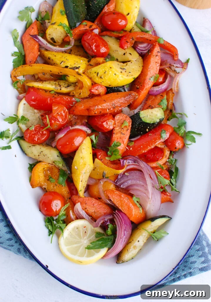 Mediterranean Roasted Vegetables on white and blue plate, garnished with fresh herbs