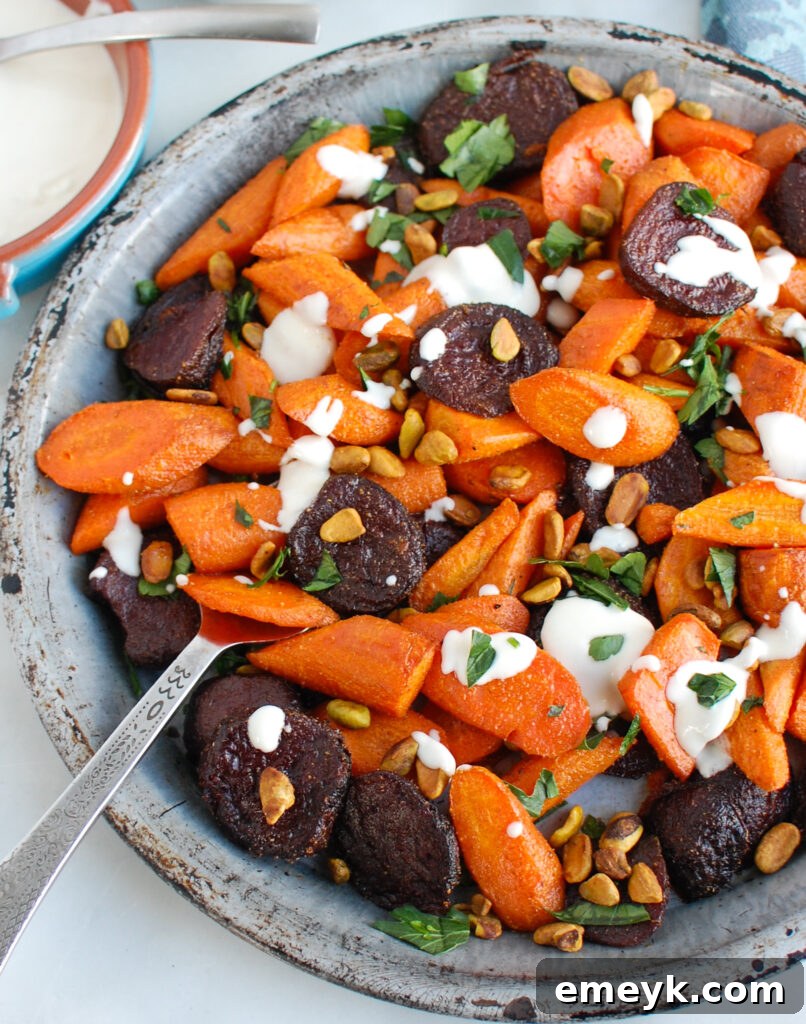 Roasted Carrots and Beets with Tahini with serving spoon