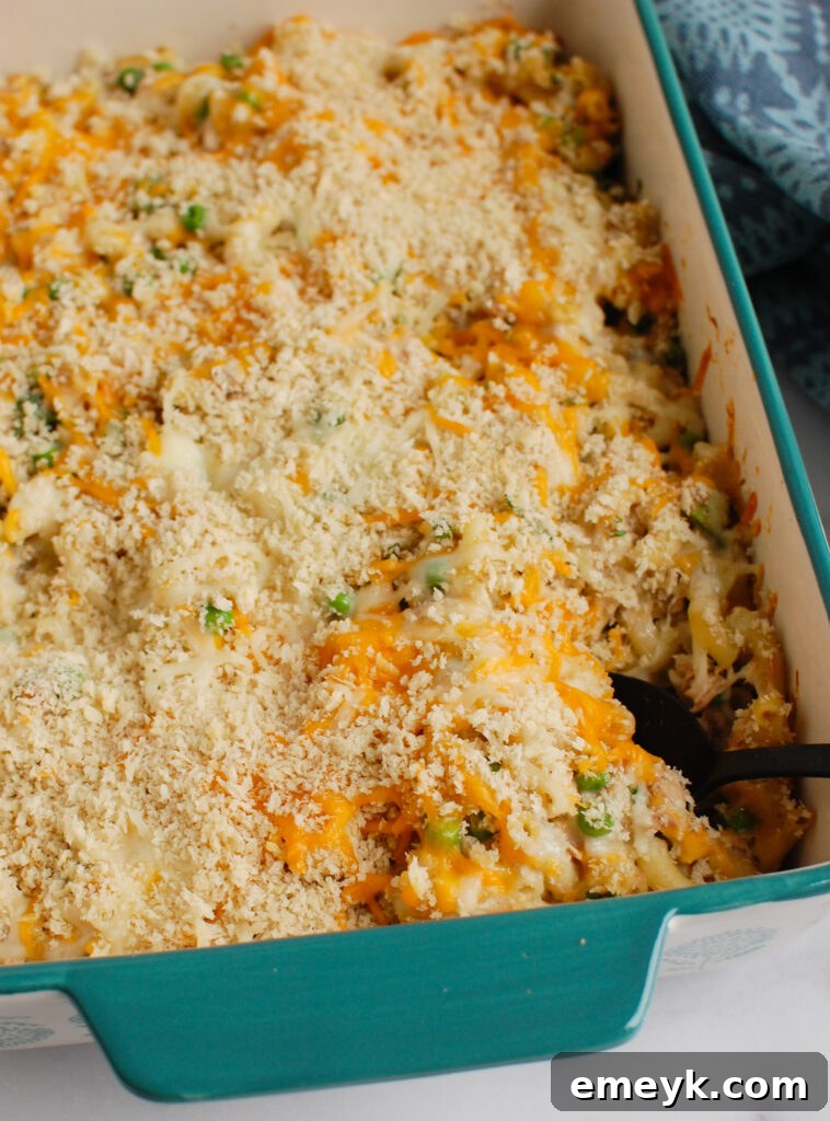 Easy Tuna Noodle Casserole with serving spoon, freshly baked