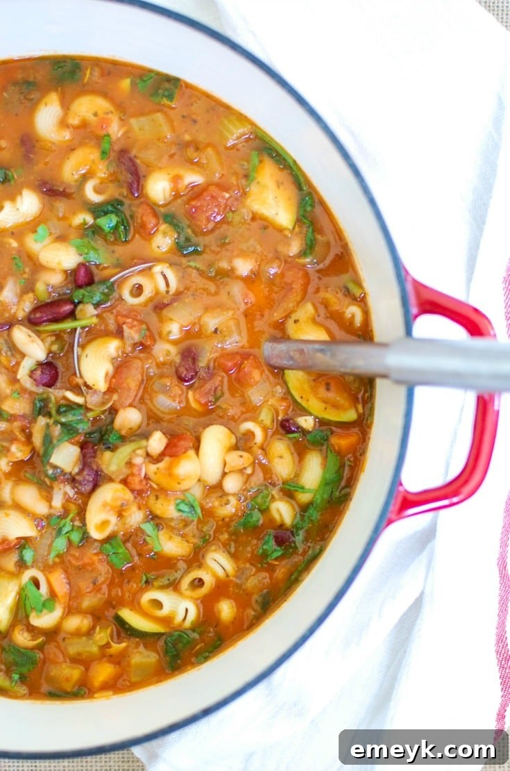 A steaming bowl of hearty Homemade Minestrone Soup with pasta and vegetables