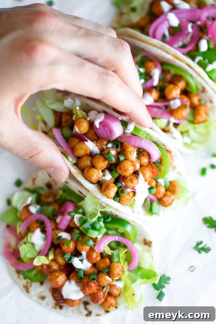 Spicy Buffalo Chickpea Tacos garnished with green onions and ranch