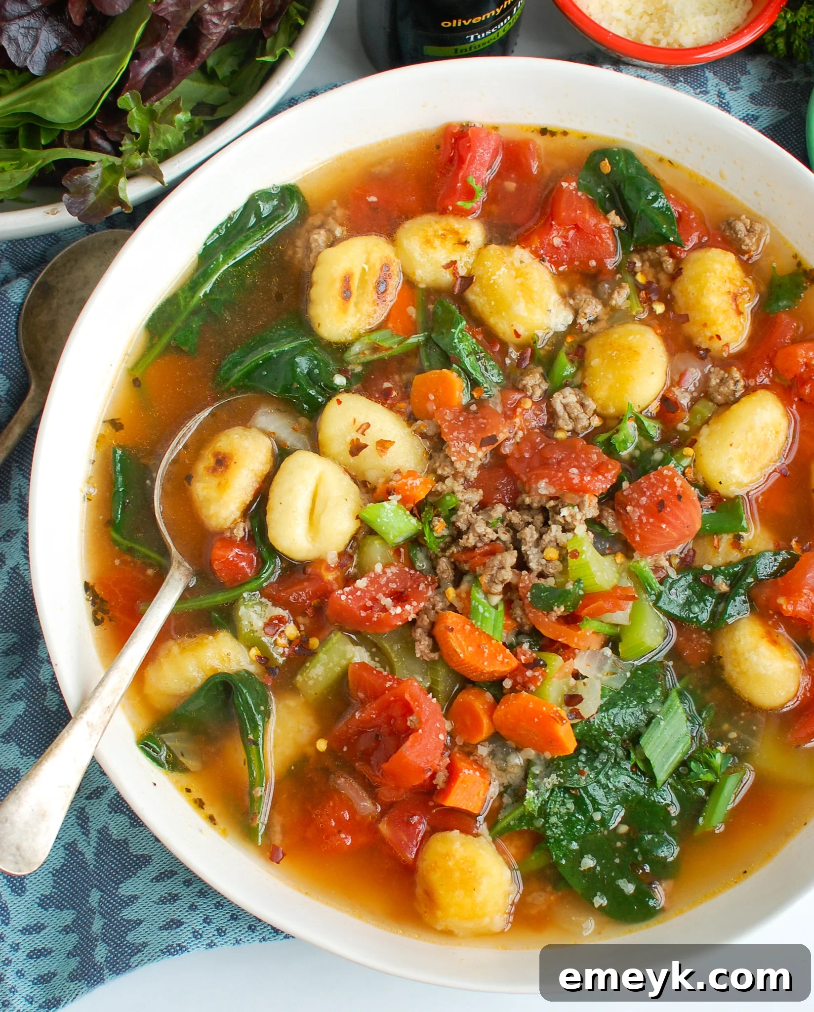 A bowl of Easy Sausage Gnocchi Soup with a spoon, ready to enjoy.