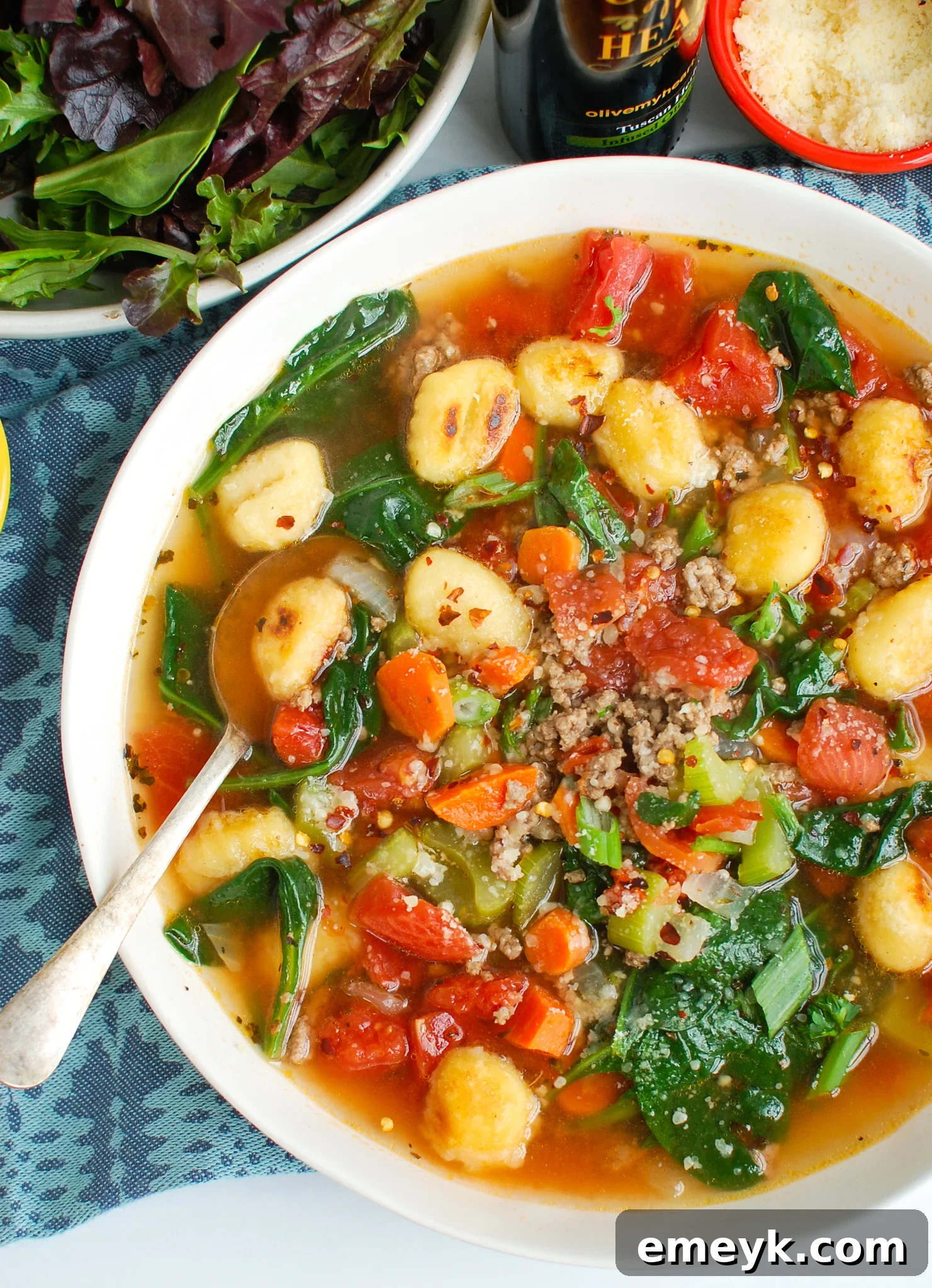 Easy Sausage Gnocchi Soup with a blue napkin, inviting to a cozy meal.
