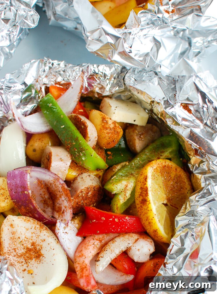 Grilled Surf & Turf Foil Dinners 2 Sausage and Shrimp Foil Packets cooking in the foil
