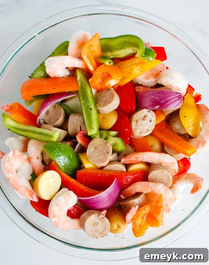 Grilled Surf & Turf Foil Dinners 5 Fresh ingredients for Sausage and Shrimp Foil Packets in a clear bowl