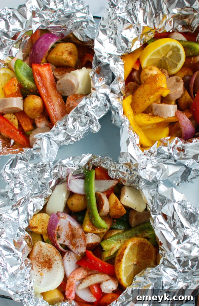 Grilled Surf & Turf Foil Dinners 7 Cooked Sausage and Shrimp Foil Packets in foil ready to serve