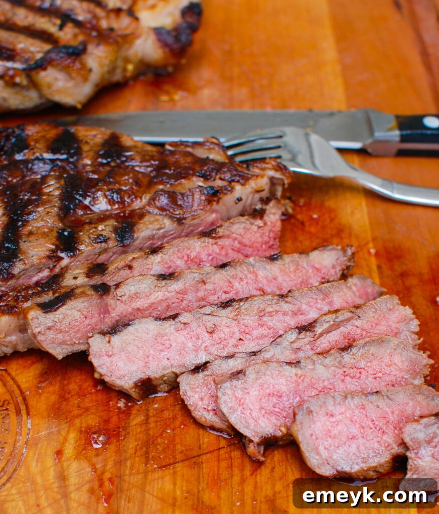Sliced Lemon Garlic Butter Grilled Ribeye, showing the perfect medium-rare doneness and juicy interior.