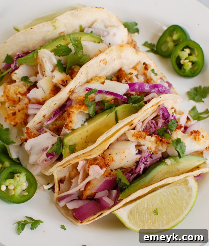 Easy Cod Fish Tacos on white plate with fresh cilantro and lime