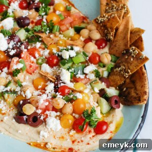 Hummus Platter on teal plate with vibrant toppings
