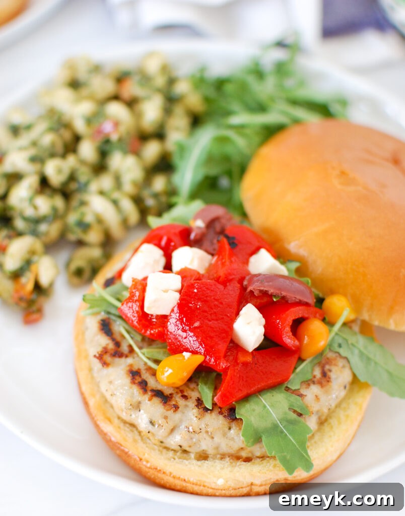 Greek Chicken Burger on a bun with generous toppings