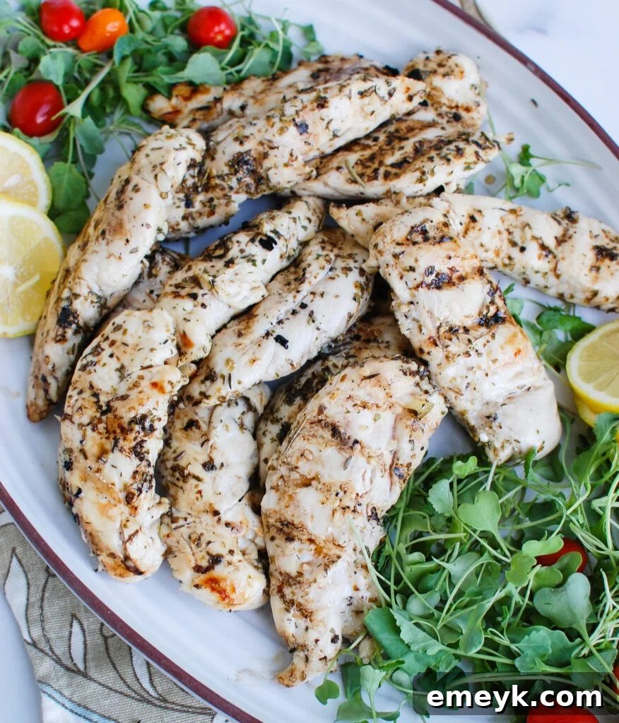Lemon Marinade for Chicken served with fresh greens and lemon slices.