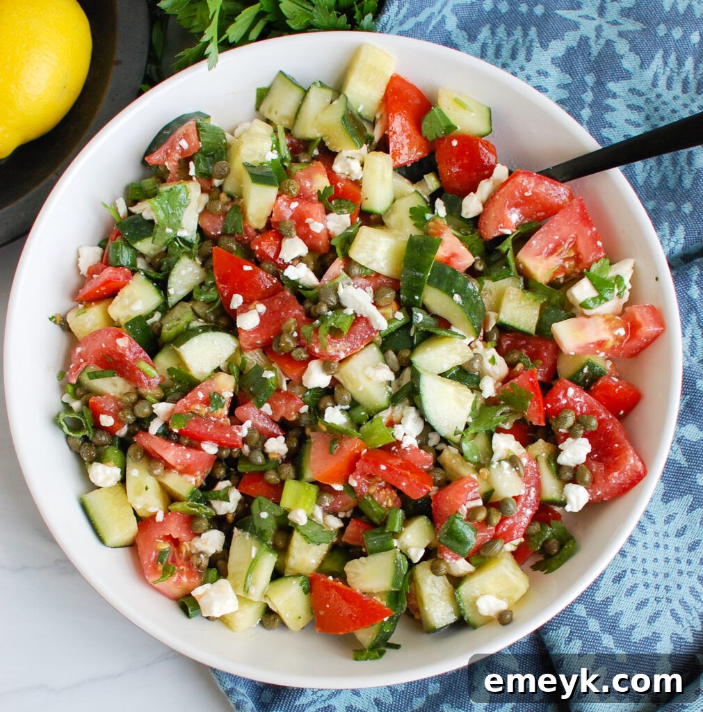 Close-up of Cucumber Salad with Capers and a serving spoon, highlighting textures