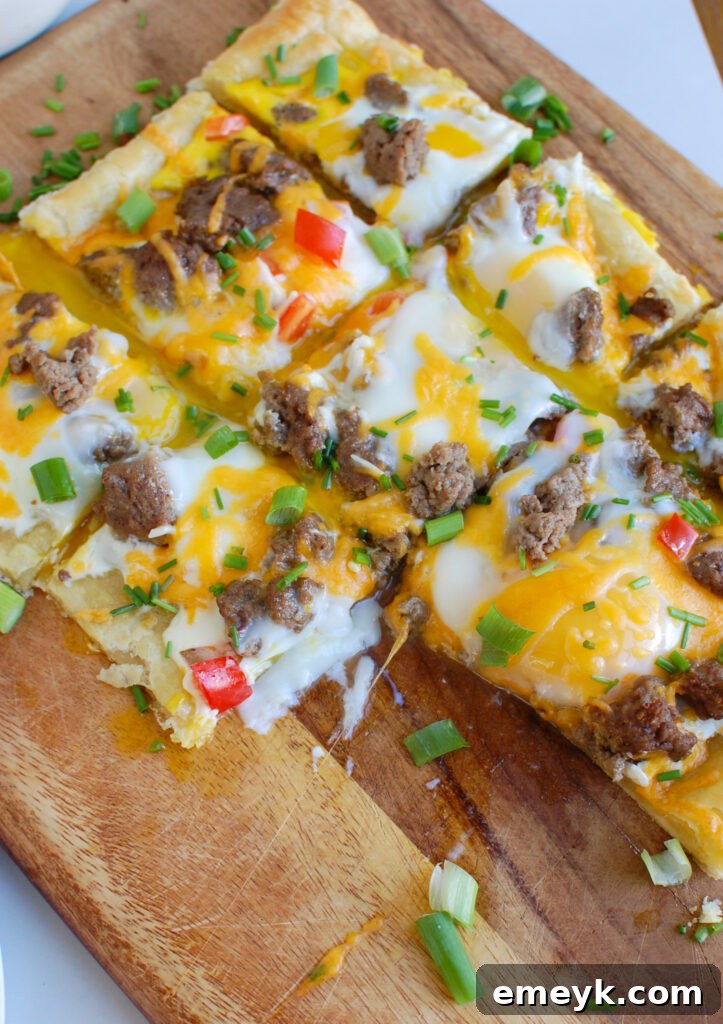 A close-up shot of the Turkey Sausage and Egg Puff Pastry Pizza, emphasizing the texture of the pastry and the appetizing arrangement of toppings.