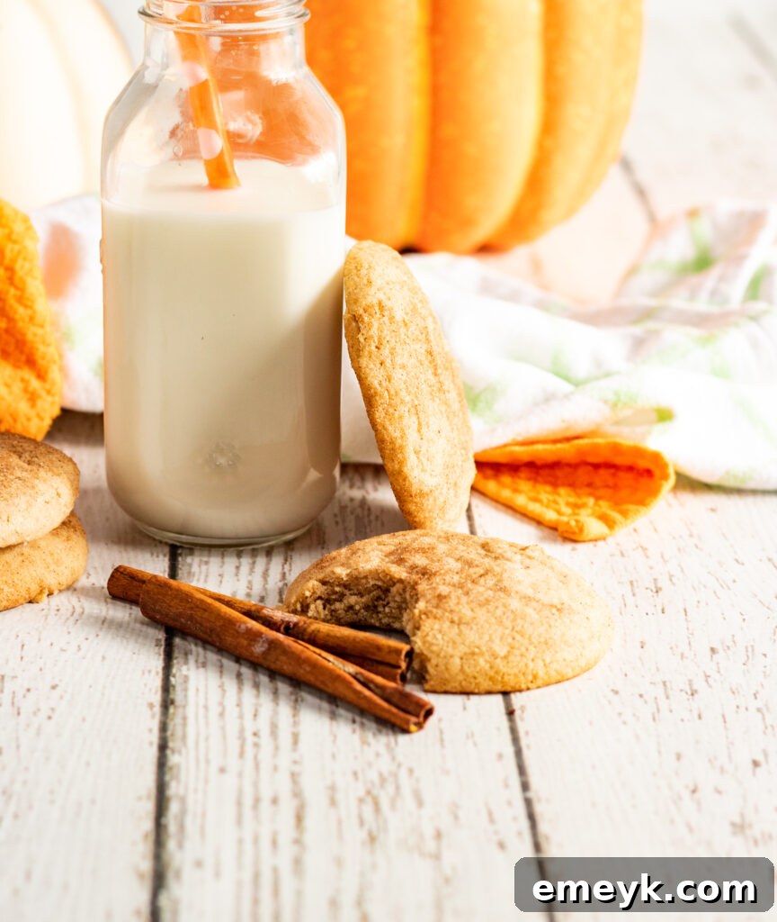 Freshly baked Pumpkin Snickerdoodles served with a glass of milk
