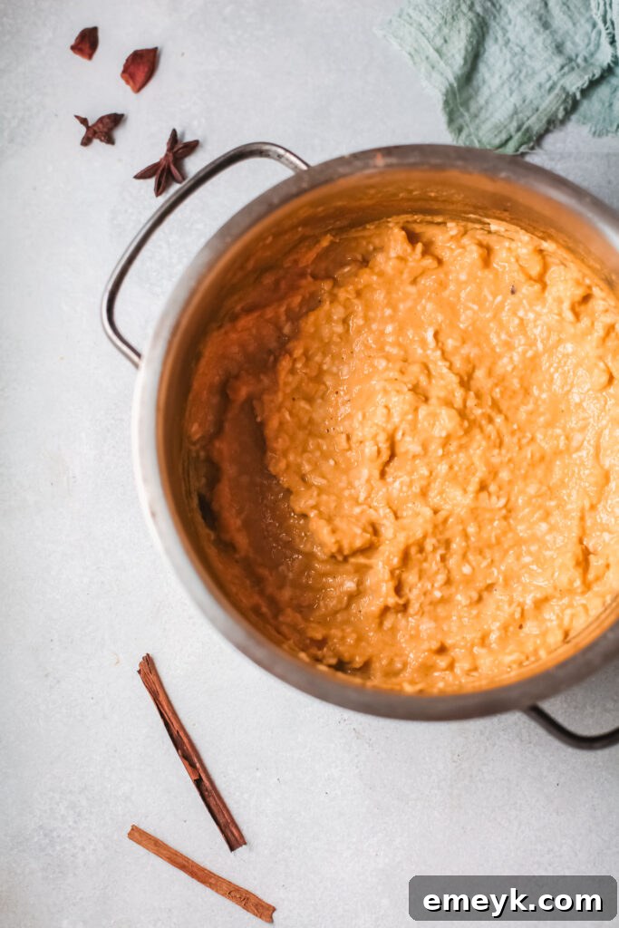 Large pot filled with creamy Easy Pumpkin Oatmeal, ready to be served for a family breakfast.