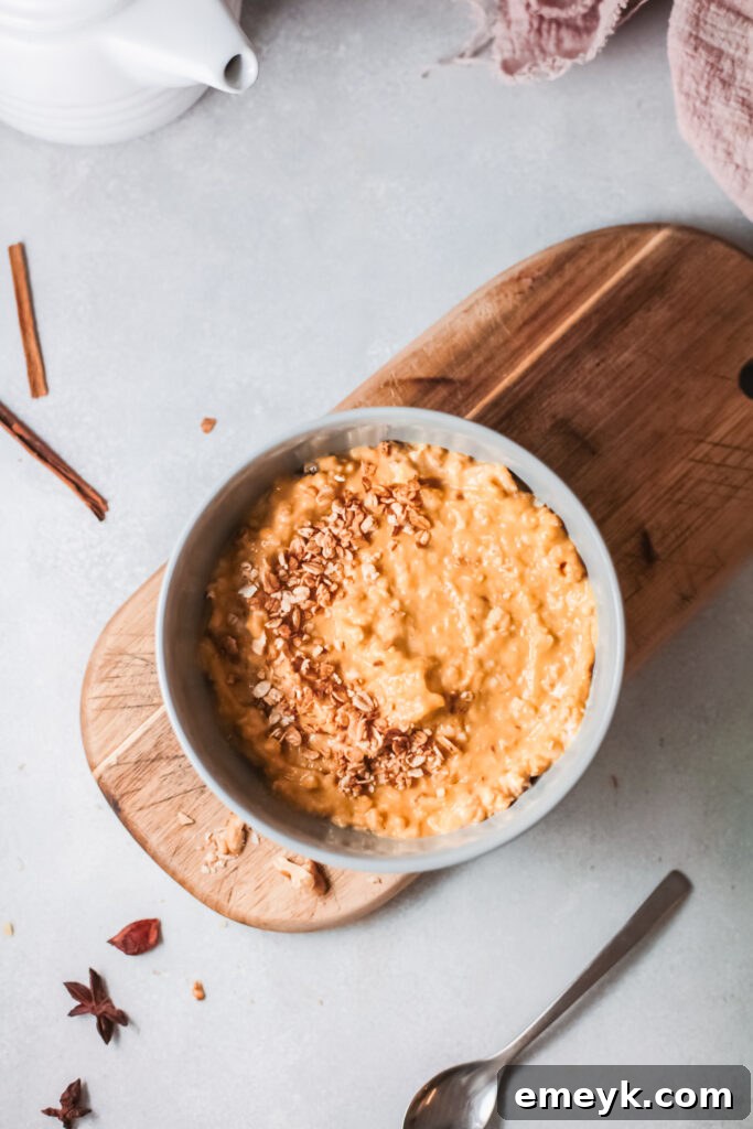 Prepared Pumpkin Oatmeal in a bowl on a rustic wooden board, ready to be enjoyed as a hearty breakfast.