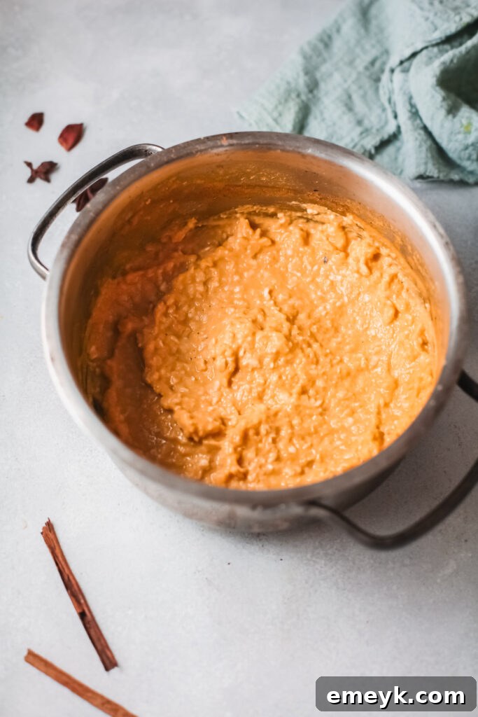 A pot of finished Easy Pumpkin Oatmeal, steaming gently, ready for toppings.