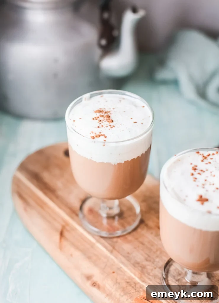Instant Pot Spiced Chai Latte 5 Instant Pot Chai Tea Latte in a glass mug, garnished with a dusting of cinnamon and a cinnamon stick.