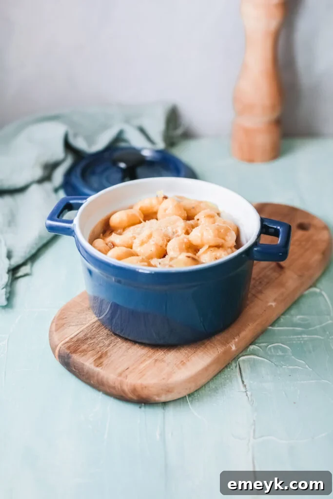 One Pot French Onion Gnocchi served in a rustic blue pot, ready to be enjoyed.