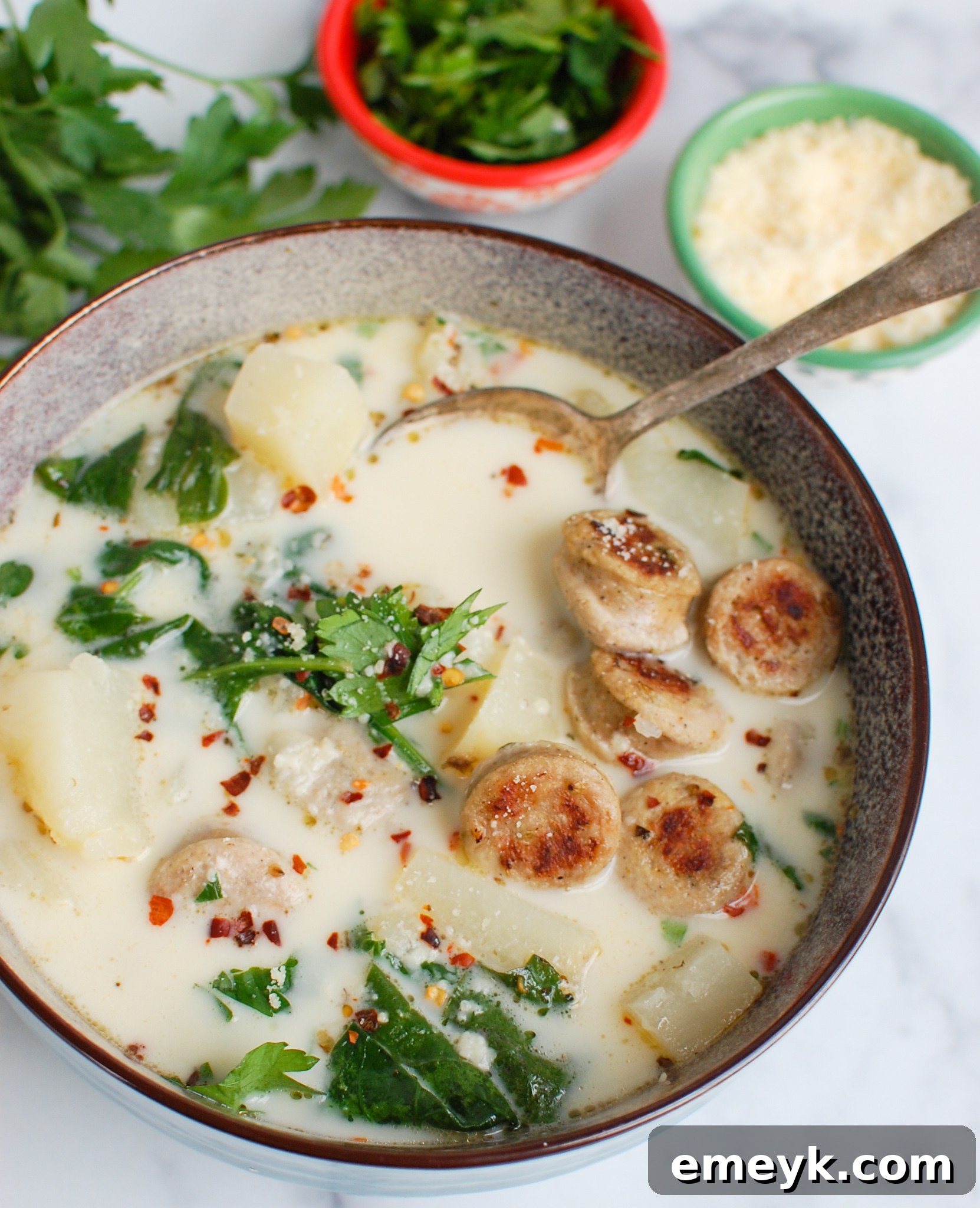 Hearty Slow Cooker Zuppa Toscana 5 Slow Cooker Zuppa Toscana with tender potatoes visible.