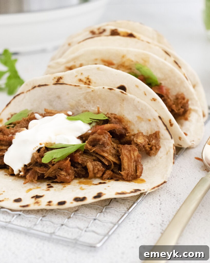 Instant Pot Carnitas served in tacos with fresh toppings
