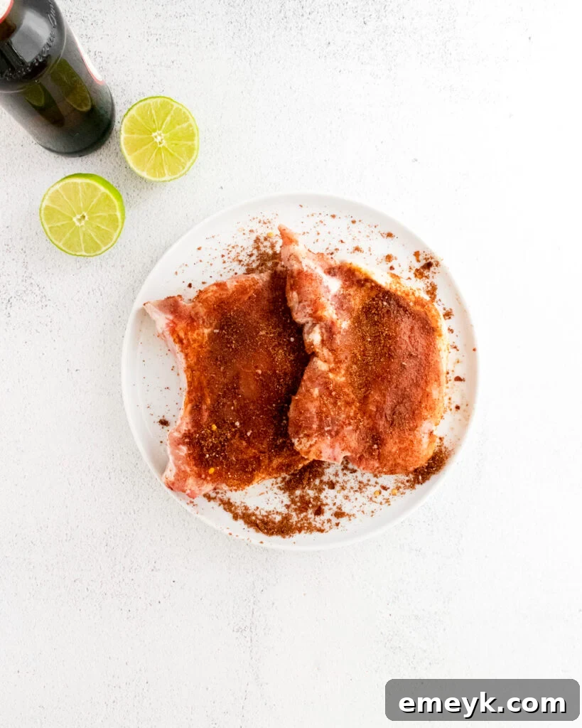 Pork chops coated generously with spice rub for Instant Pot Carnitas