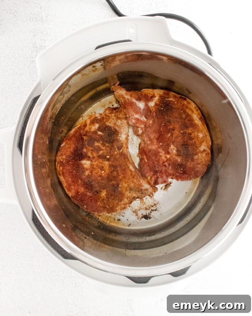 Instant Pot Carnitas pork chops cooking in the Instant Pot