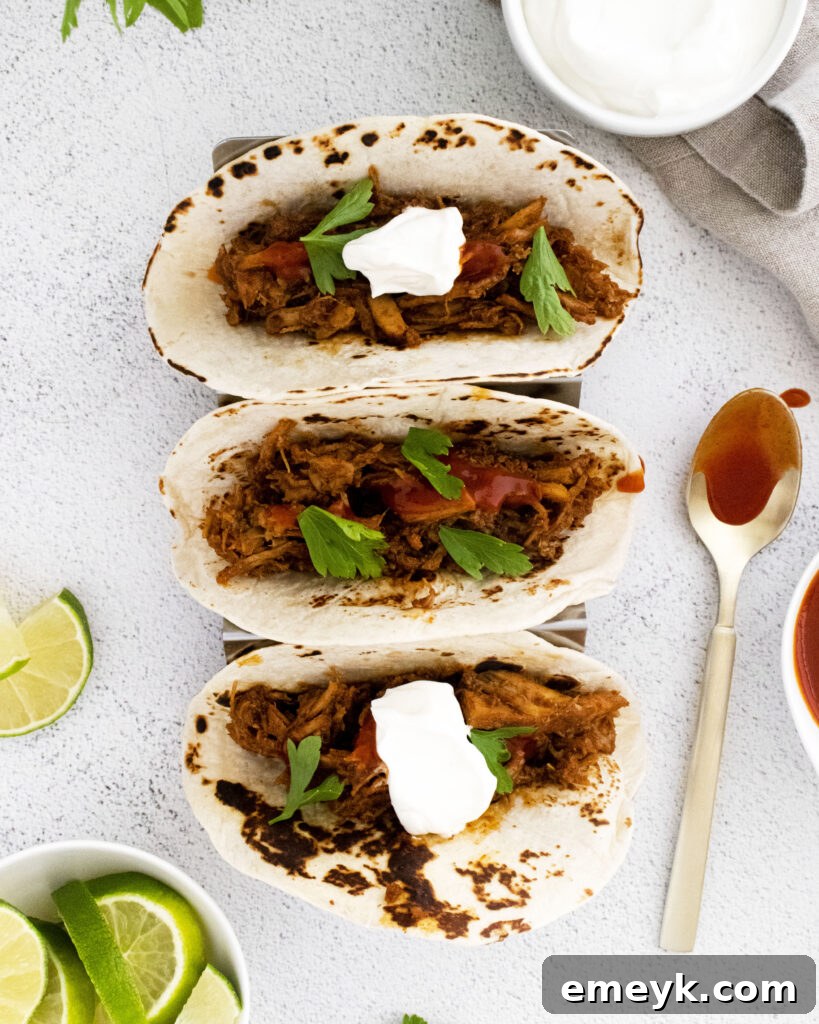 Instant Pot Carnitas served in a taco holder with various garnishes