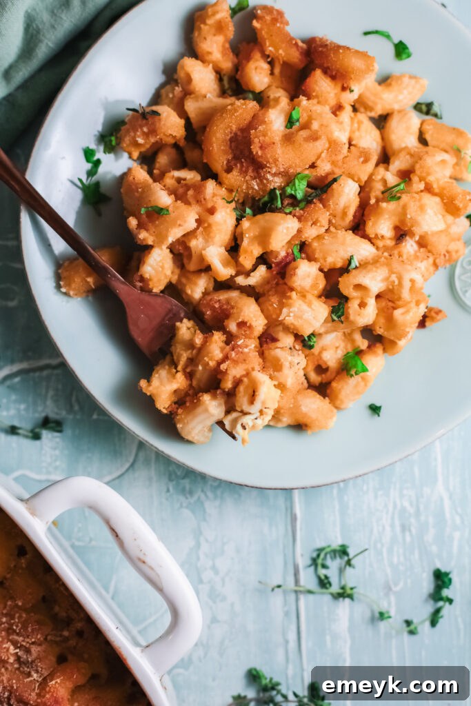 Creamy Pumpkin Mac and Cheese served on a teal plate, ready to be enjoyed.