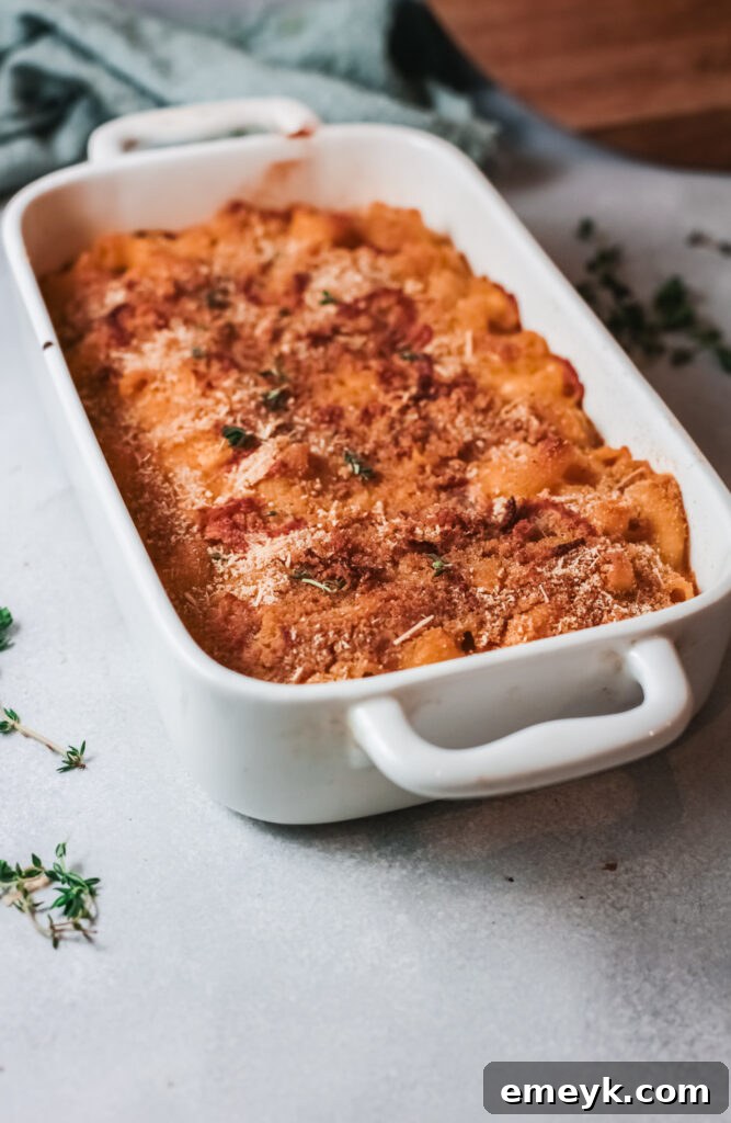 Pumpkin Mac and Cheese in a white baking dish, ready to be topped and baked.