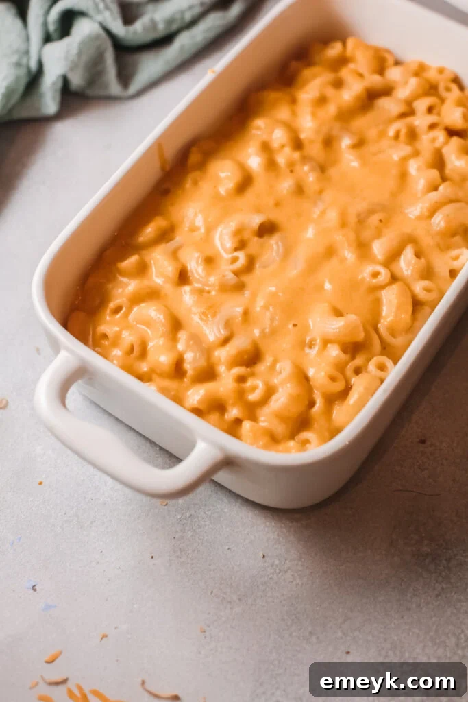 Cooked pasta and shredded cheddar cheese mixed into the pumpkin sauce.