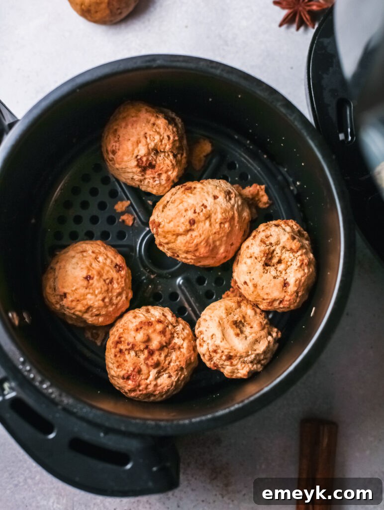 Air Fryer Donut Holes placed in a single layer in the air fryer basket, ready for cooking.