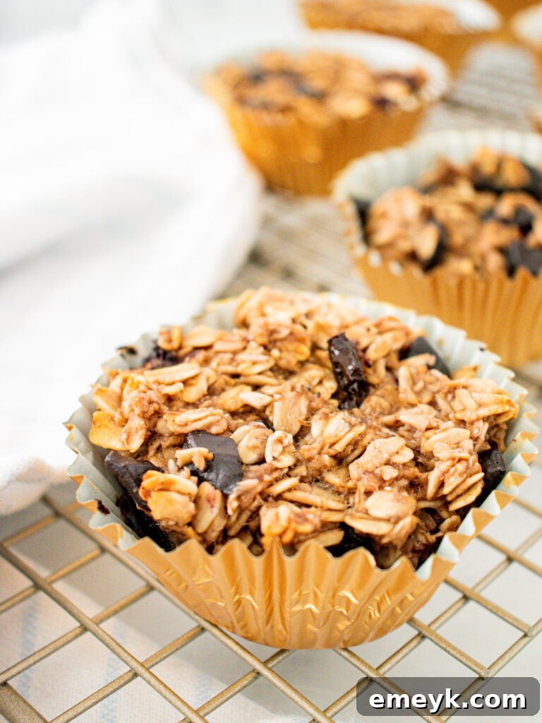 Wholesome Banana Oat Muffins 5 A close-up shot of a Banana Oatmeal Muffin nestled in a gold foil liner, ready to be enjoyed.