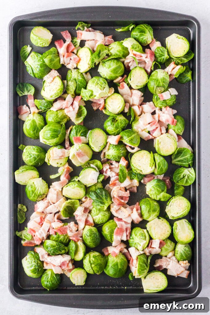Raw ingredients for Roasted Brussels Sprouts with Bacon, including halved Brussels sprouts, chopped bacon, and minced garlic, ready for mixing.