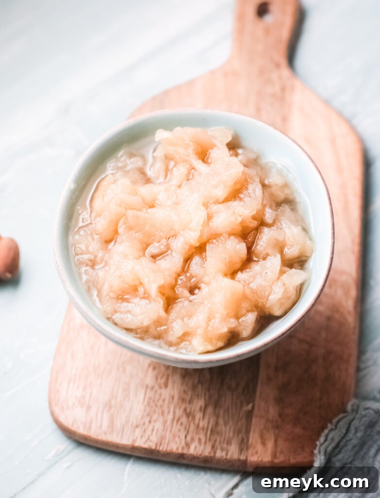 Vibrant Instant Pot Applesauce in a rustic teal bowl, ready to be enjoyed.