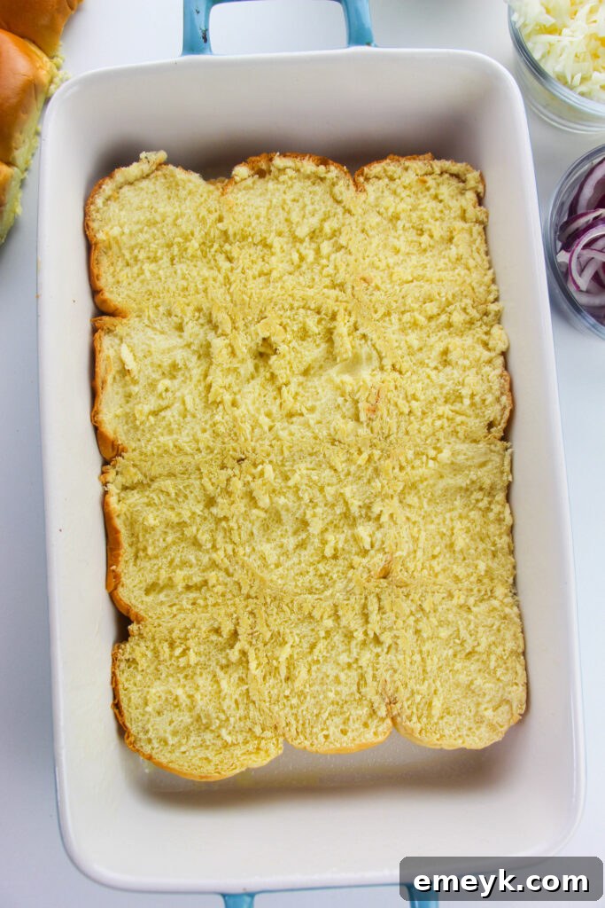 Simple Savory Chicken Sliders 7 Bottom half of slider buns in a baking dish