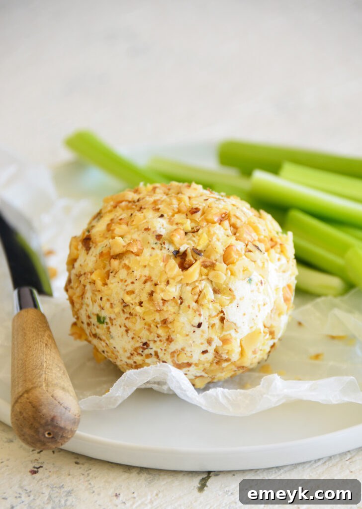 Crafting the Perfect Cheese Ball 2 Delicious homemade cheese ball with celery sticks and crackers, ready to serve.