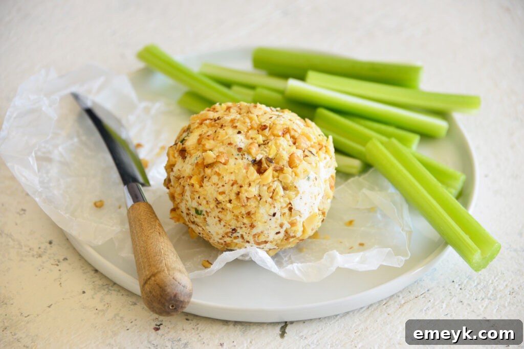 Crafting the Perfect Cheese Ball 3 A sharp knife slicing into a creamy cheese ball, ready to be served at a gathering.