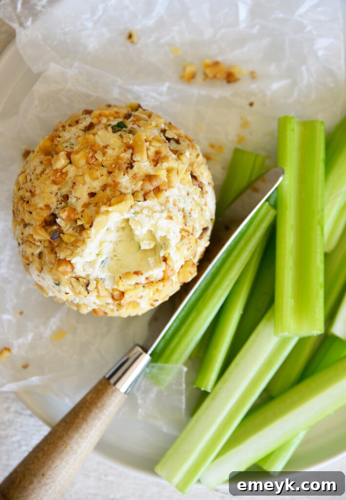Crafting the Perfect Cheese Ball 5 A beautifully presented cheese ball on a white plate, ready for guests to enjoy.