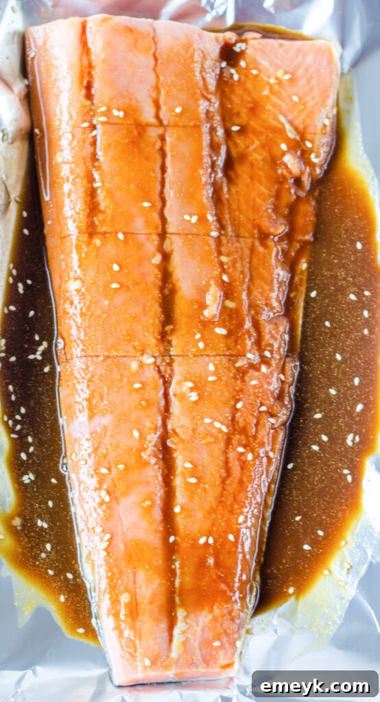 Perfect Glazed Teriyaki Salmon 4 Raw salmon fillets marinating in a homemade teriyaki sauce before baking