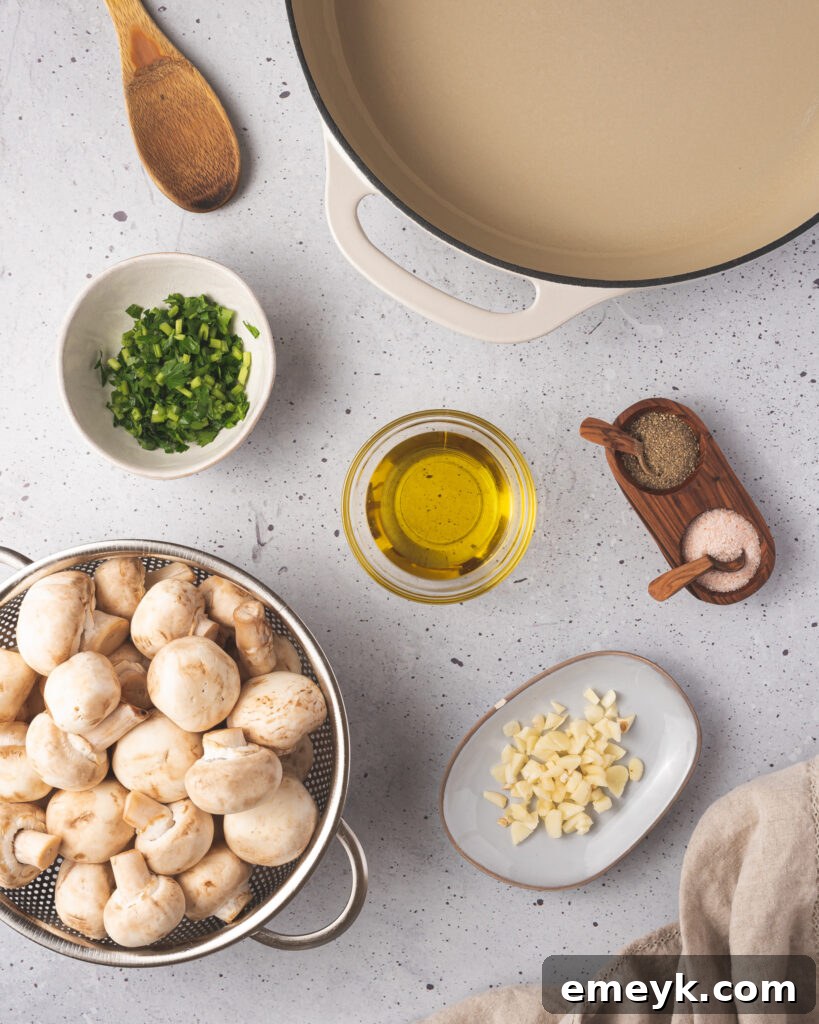 Golden Garlic Mushrooms 3 Fresh ingredients for garlic sautéed mushrooms: whole white mushrooms, garlic cloves, olive oil, and parsley.