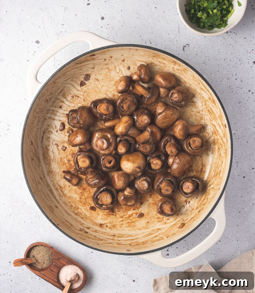 Golden Garlic Mushrooms 7 Garlic sautéed mushrooms browning in a skillet.