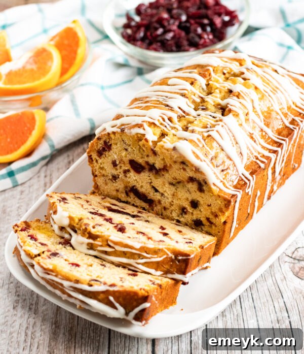 Freshly baked cranberry orange bread loaf, cooling on a wire rack.