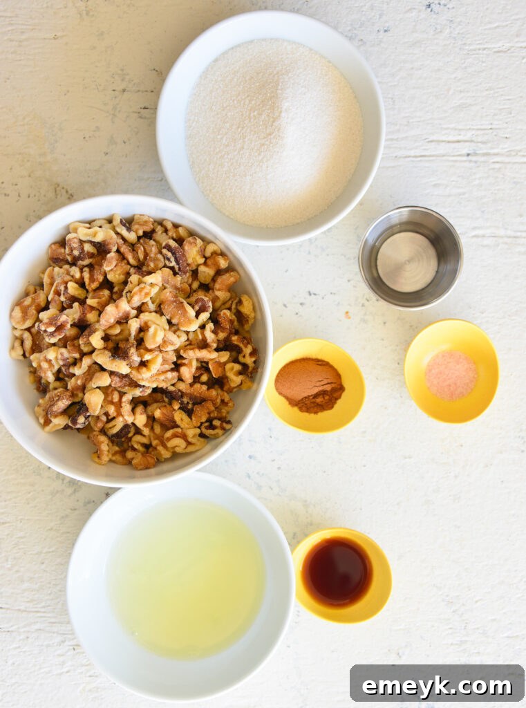 A selection of fresh ingredients laid out on a kitchen counter, including walnuts, sugar, vanilla extract, cinnamon, and an egg, ready for making candied walnuts.