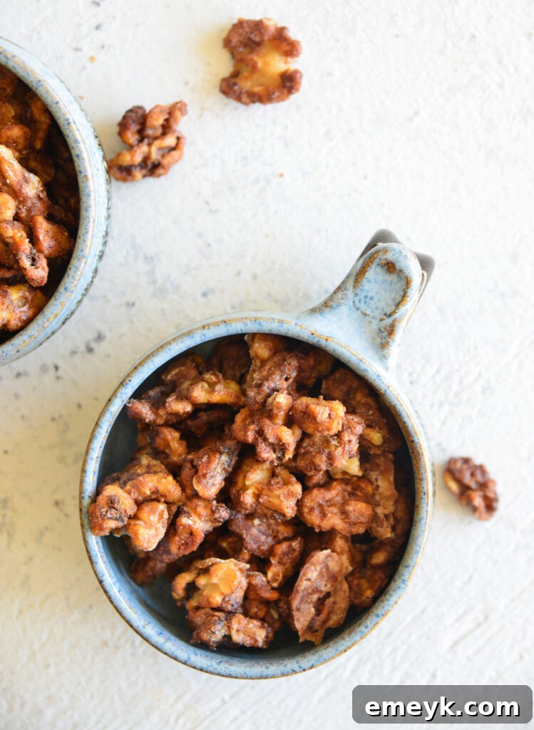 An overhead shot of a bowl filled with freshly prepared Easy Candied Walnuts, highlighting their appealing texture and golden sheen.