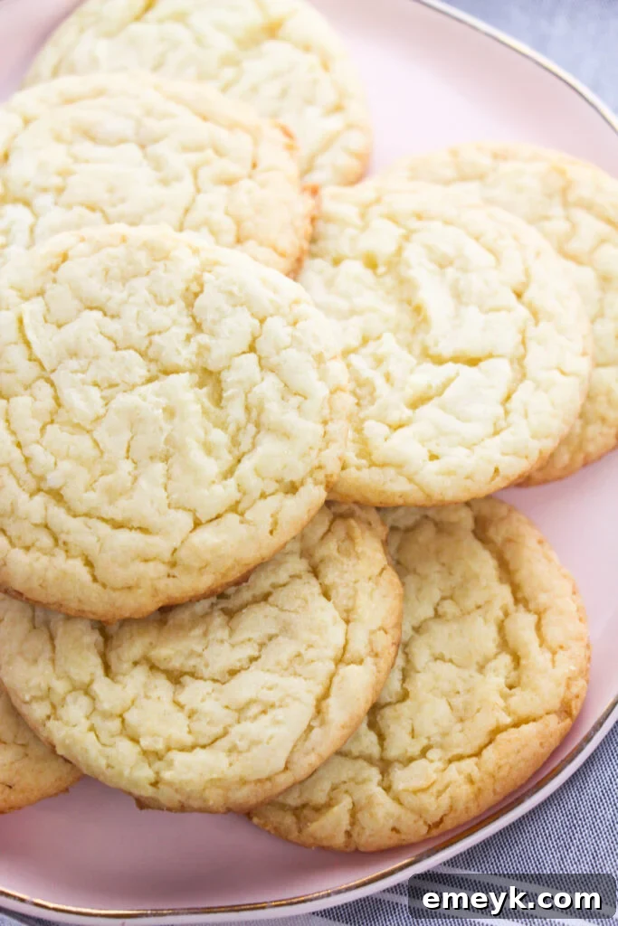 Iced Easy Cake Mix Sugar Cookies on a plate with sprinkles